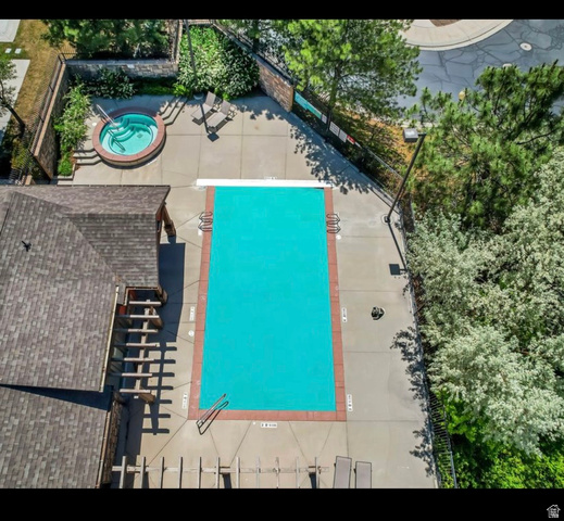 14797 South Chandlerpoint Way Draper, UT 84020 - Photo 29 of 33 Rectangular swimming pool with a surrounding concrete deck and a separate circular spa