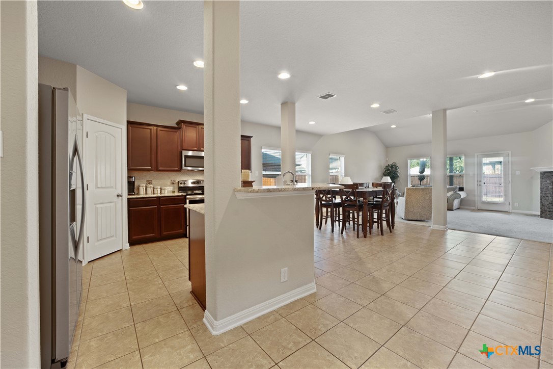 232 Albarella Cibolo, TX 78108 - Photo 42 of 42 a kitchen with stainless steel appliances kitchen island granite countertop a refrigerator and cabinets