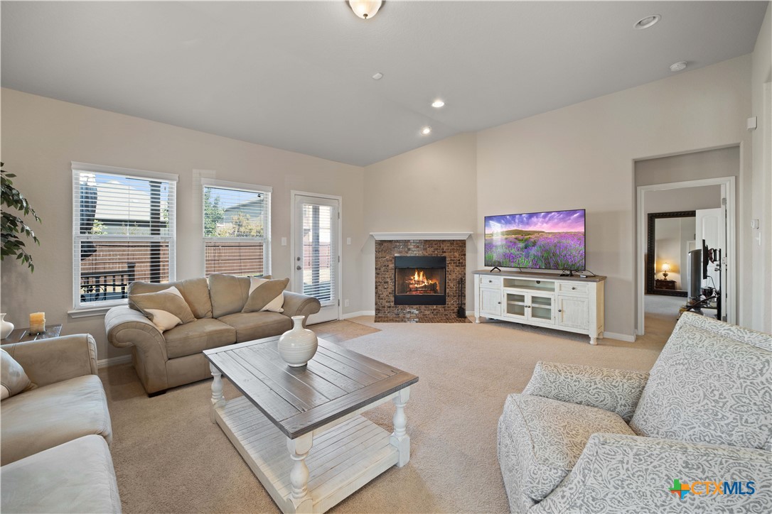232 Albarella Cibolo, TX 78108 - Photo 17 of 42 a living room with furniture a flat screen tv and a fireplace