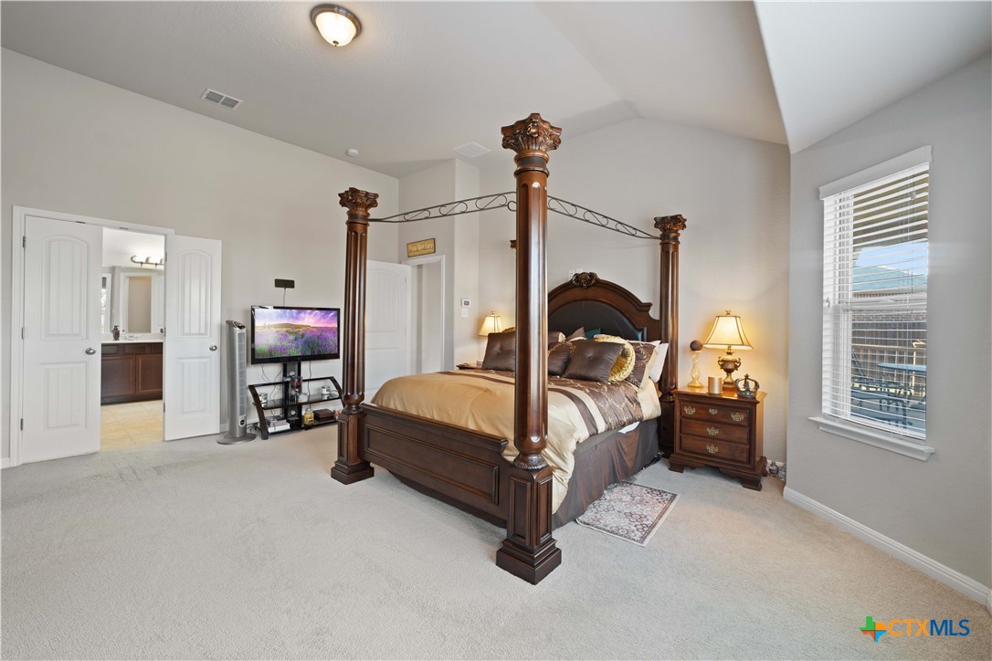 232 Albarella Cibolo, TX 78108 - Photo 21 of 42 a bedroom with bed and a chandelier