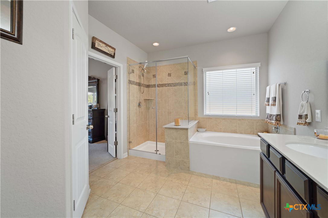 232 Albarella Cibolo, TX 78108 - Photo 23 of 42 a bathroom with a tub sink and a shower