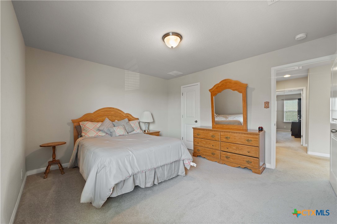 232 Albarella Cibolo, TX 78108 - Photo 32 of 42 a bedroom with a bed and a dresser