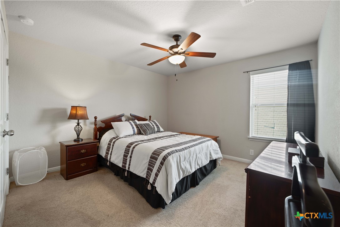 232 Albarella Cibolo, TX 78108 - Photo 34 of 42 a bedroom with a bed and a chandelier