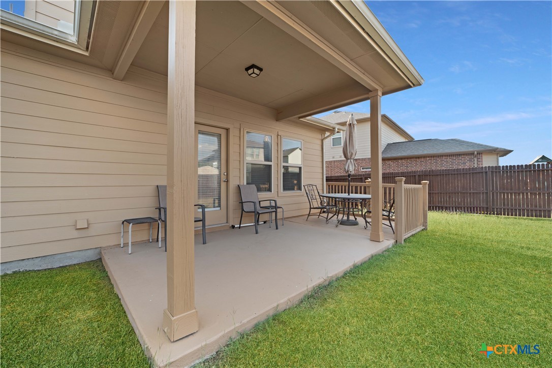 232 Albarella Cibolo, TX 78108 - Photo 36 of 42 a view of a patio with table and chairs under an umbrella