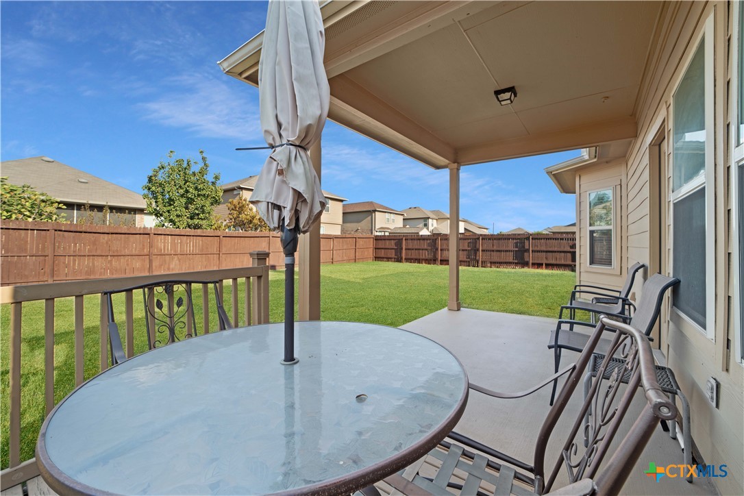232 Albarella Cibolo, TX 78108 - Photo 37 of 42 a view of a patio with a table chairs potted plants and wooden fence