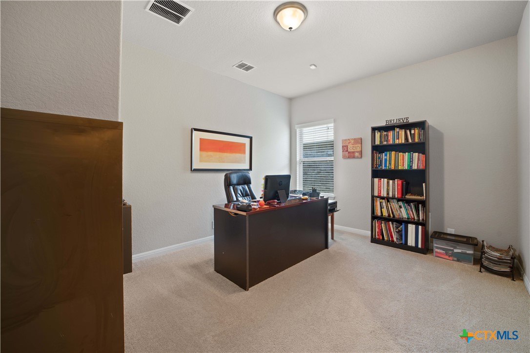 232 Albarella Cibolo, TX 78108 - Photo 8 of 42 a living room with a couch and a bookshelf