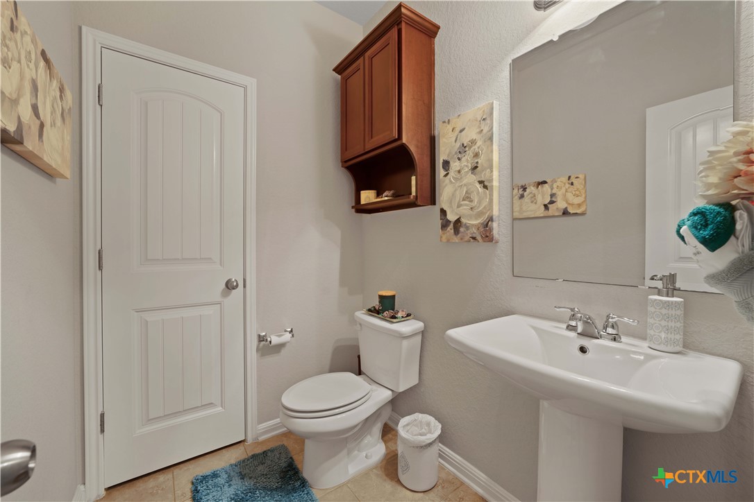 232 Albarella Cibolo, TX 78108 - Photo 10 of 42 a bathroom with a toilet a sink and a mirror