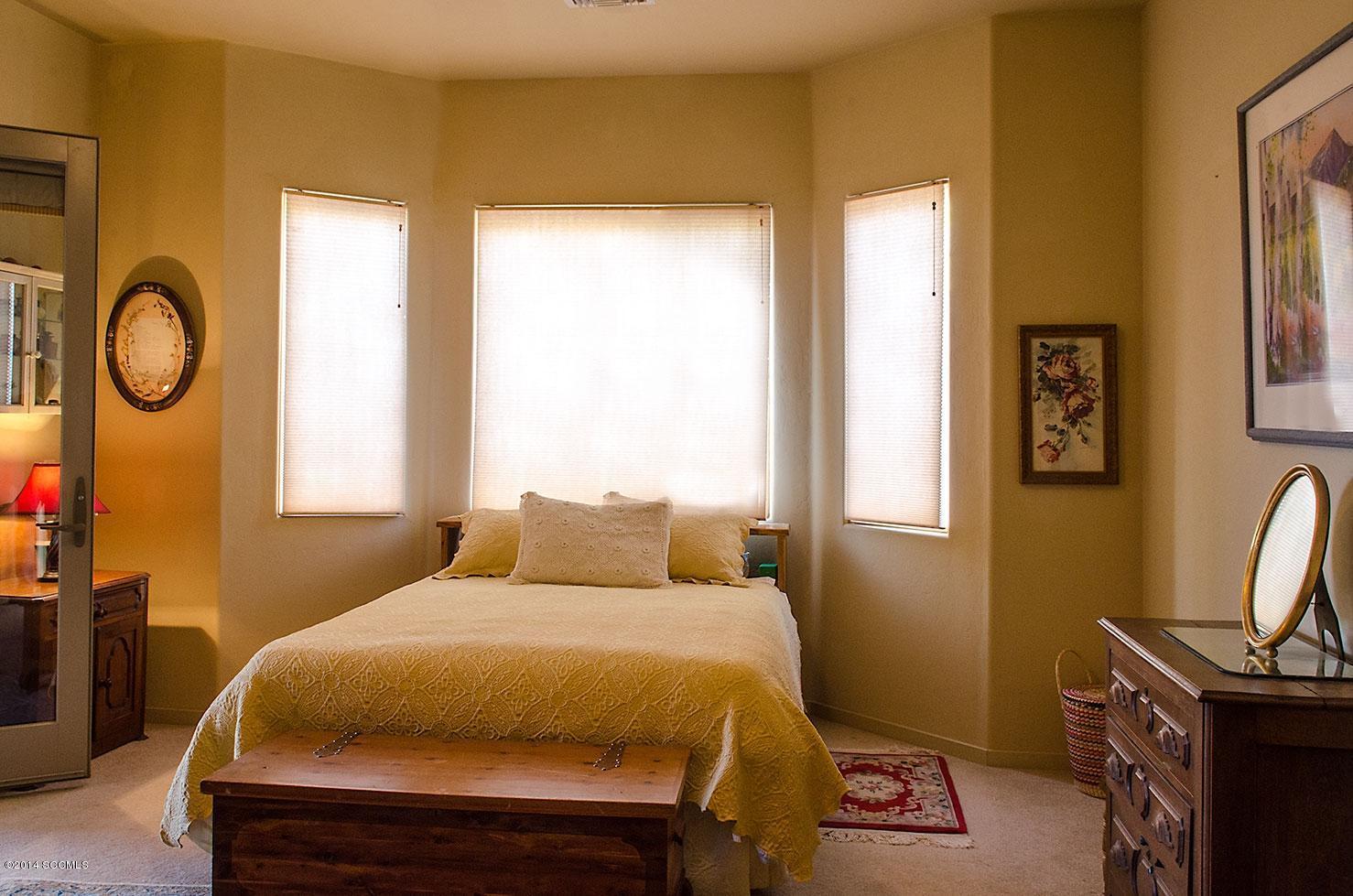 1559 Vía San Cayetano Rio Rico, AZ 85648 - Photo 9 of 16 a bedroom with a bed and a window