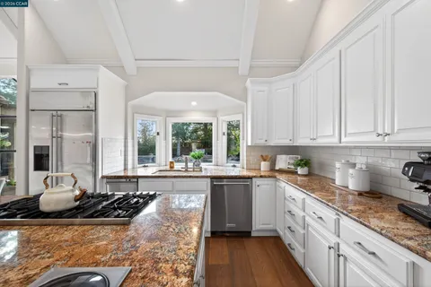 a kitchen with stainless steel appliances granite countertop a stove and a sink