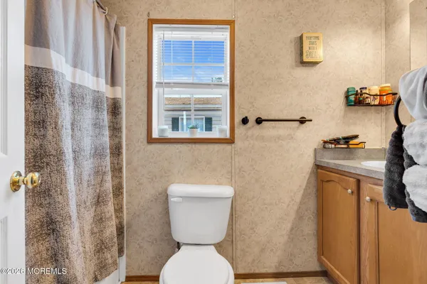 a bathroom with a toilet and a shower curtain