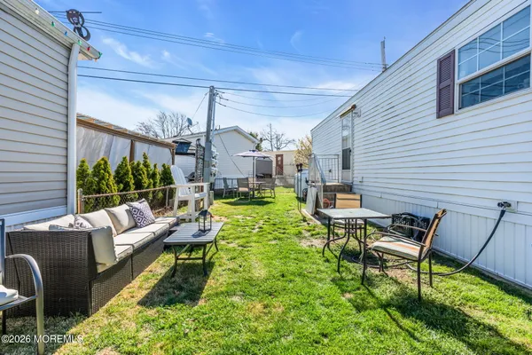 a view of a patio with table and chairs