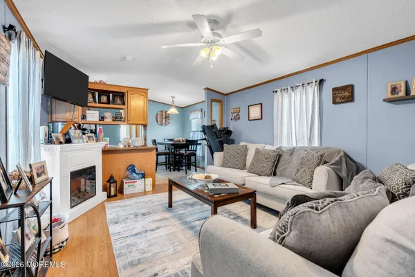 a living room with furniture kitchen view and a fireplace
