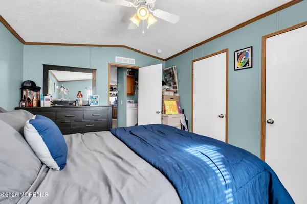 a bedroom with a bed and a large mirror