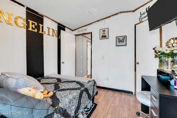 a bed room with a bed and a television