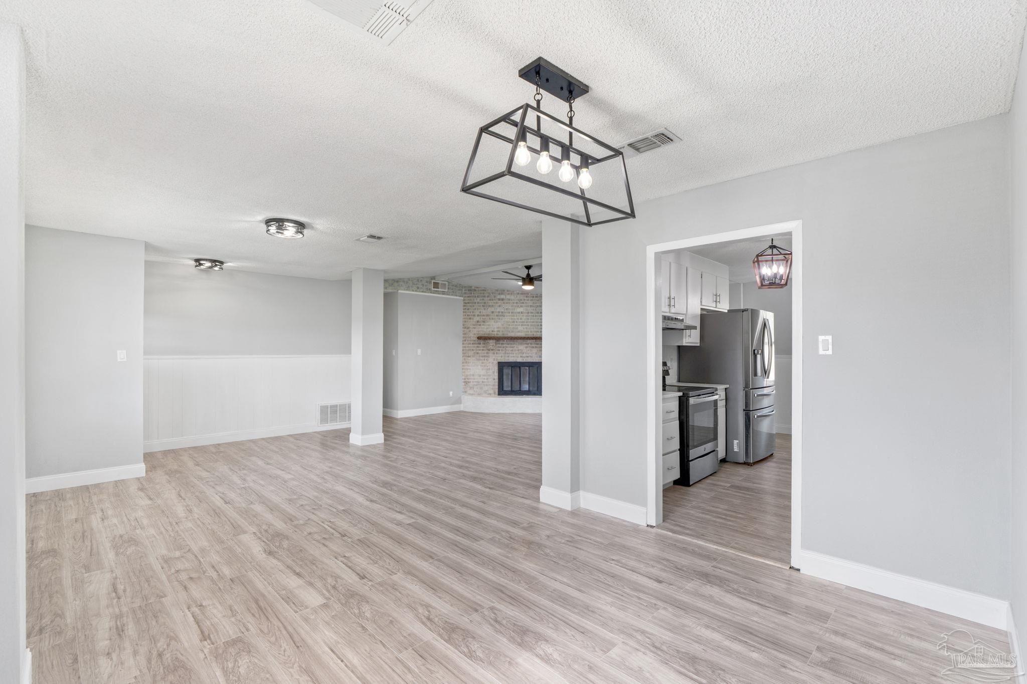 2501 Argle Road Cantonment, FL 32533 - Photo 17 of 36 a view of a room with wooden floor and chandelier
