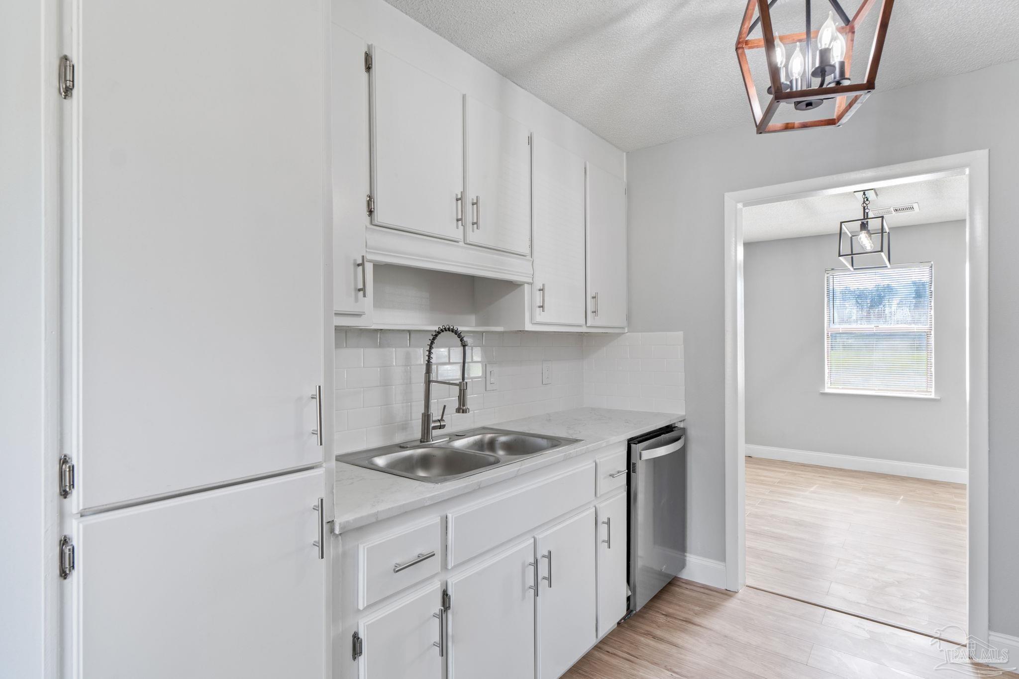 2501 Argle Road Cantonment, FL 32533 - Photo 19 of 36 a kitchen with stainless steel appliances granite countertop a sink and a refrigerator