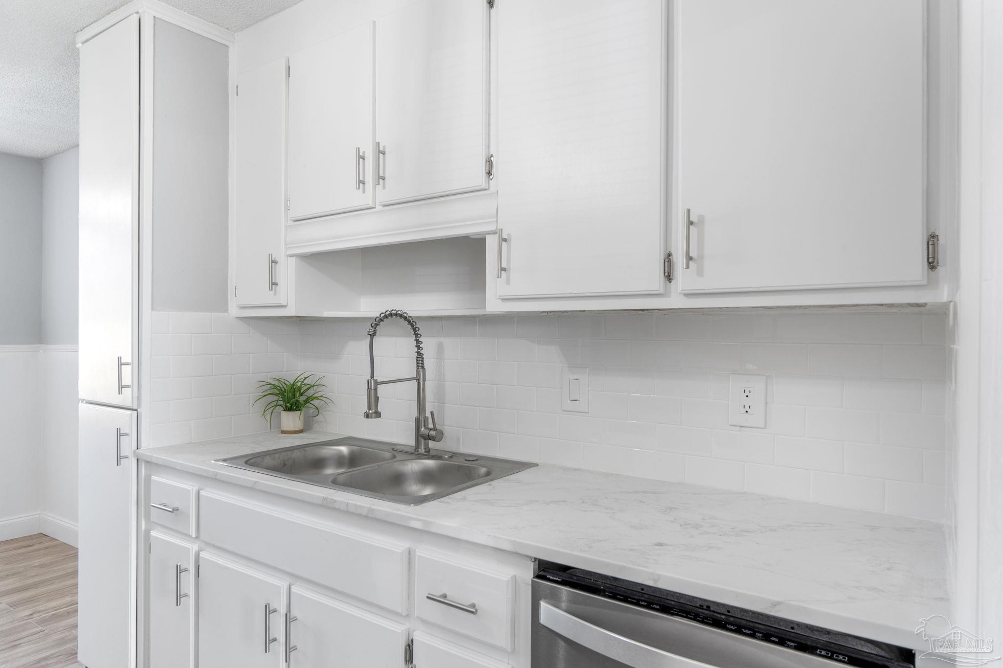 2501 Argle Road Cantonment, FL 32533 - Photo 20 of 36 a kitchen with stainless steel appliances granite countertop white cabinets and a sink