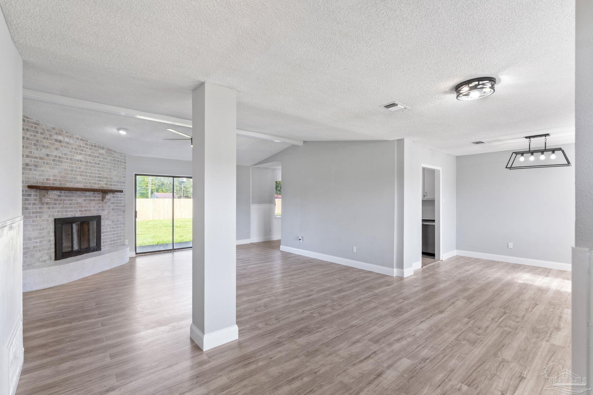 2501 Argle Road Cantonment, FL 32533 - Photo 2 of 36 a view of a room with wooden floor and fireplace