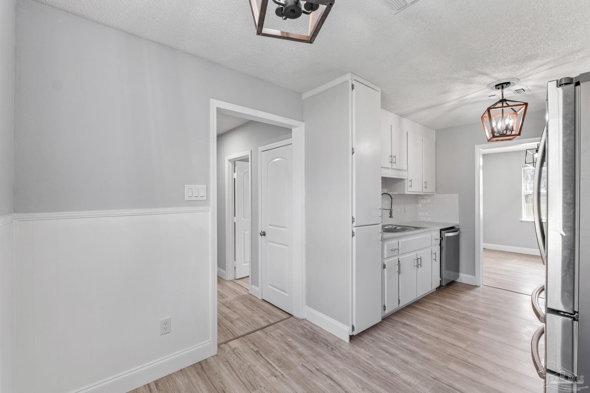 2501 Argle Road Cantonment, FL 32533 - Photo 23 of 36 a kitchen with stainless steel appliances granite countertop a refrigerator and a stove top oven