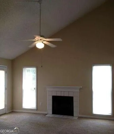 a living room with a fireplace and a window
