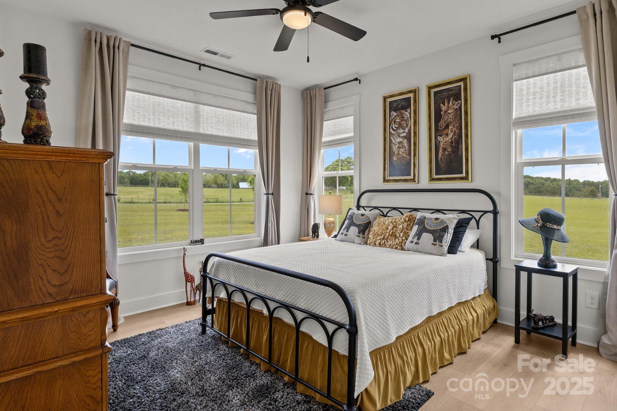 4316 Nesbit Road Monroe, NC 28112 - Photo 17 of 33 a bedroom with a bed and a chandelier