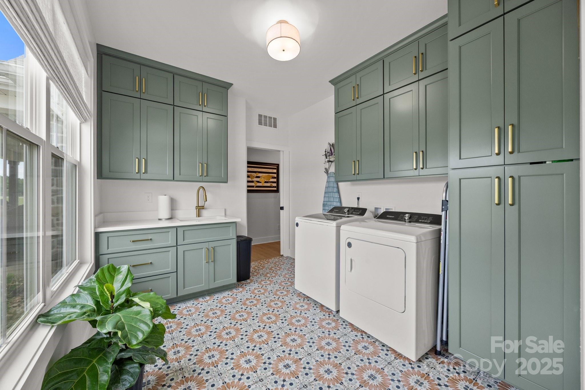 4316 Nesbit Road Monroe, NC 28112 - Photo 24 of 33 a kitchen with a refrigerator sink and white cabinets