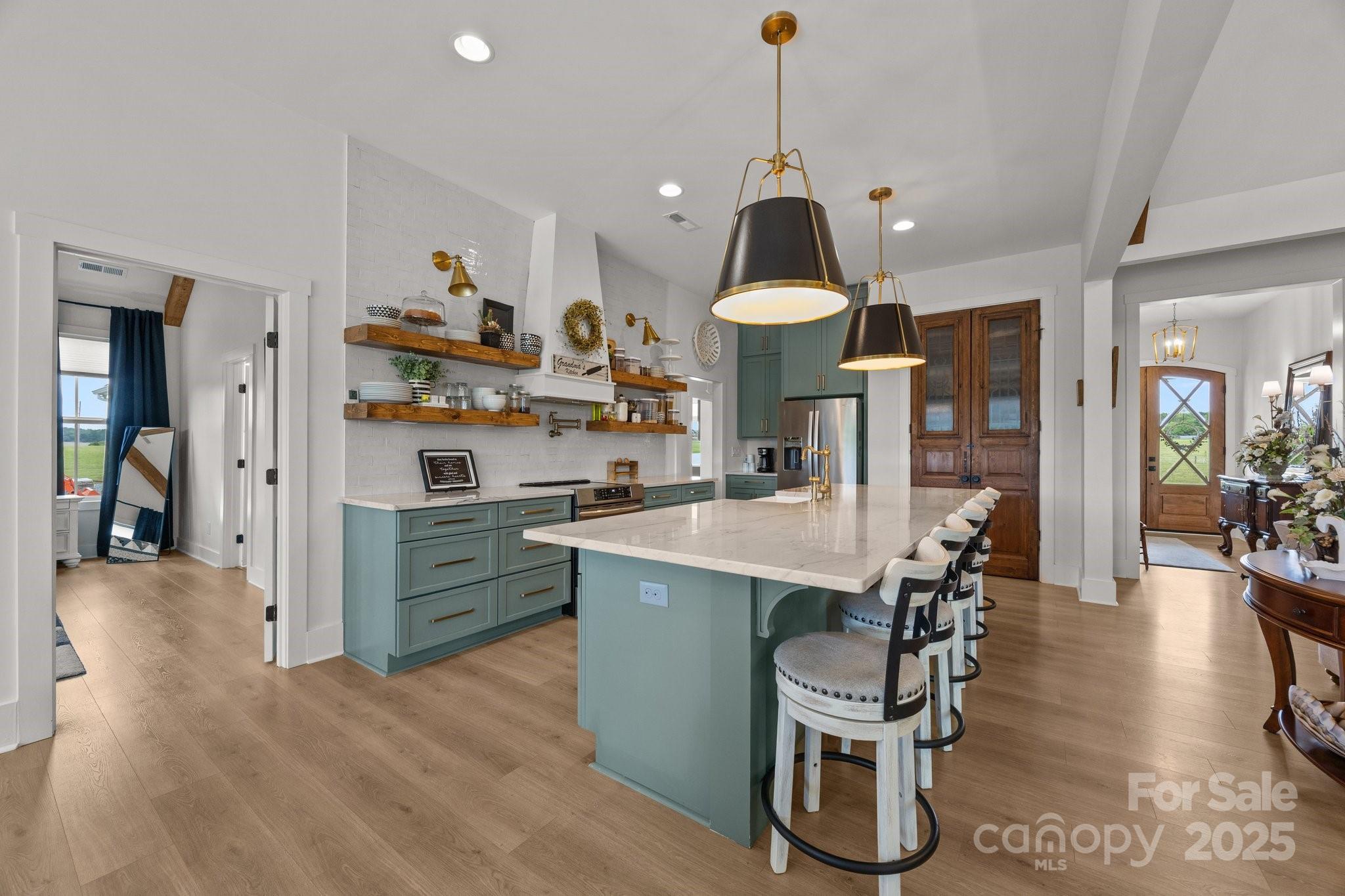 4316 Nesbit Road Monroe, NC 28112 - Photo 8 of 33 a kitchen with stainless steel appliances kitchen island granite countertop a table chairs and a refrigerator