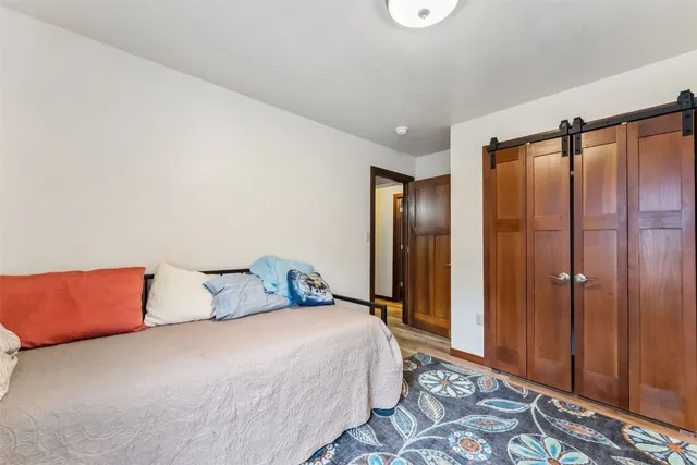 a bedroom with a bed and a mirror