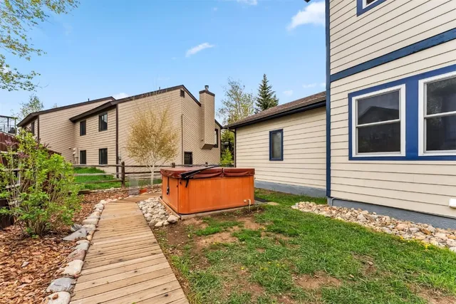 a backyard of a house with wooden floor and outdoor seating