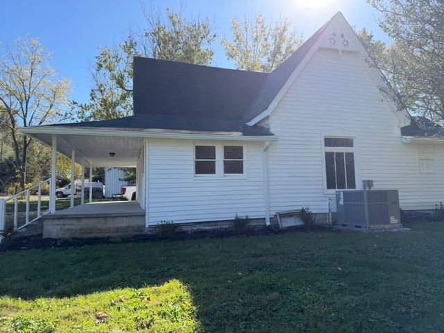a view of a house with a yard and a garden