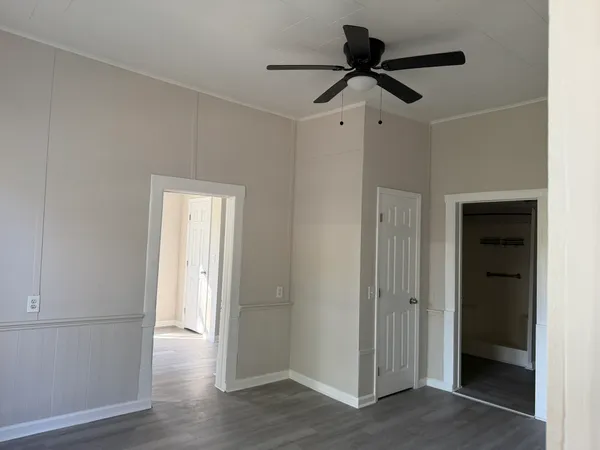 a view of empty room with wooden floor