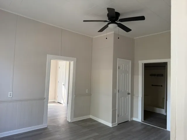 a view of empty room with wooden floor