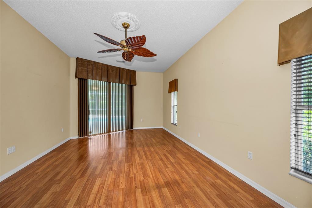 11917 Hadleigh Way Trinity, FL 34655 - Photo 24 of 84 a view of an empty room with wooden floor and a window