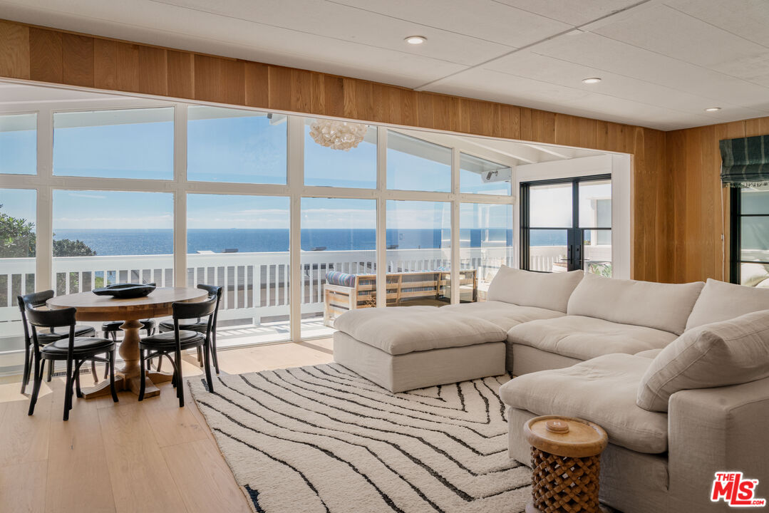 29500 Heathercliff Road, Unit 138 Malibu, CA 90265 - Photo 1 of 20 a living room with furniture and a large window