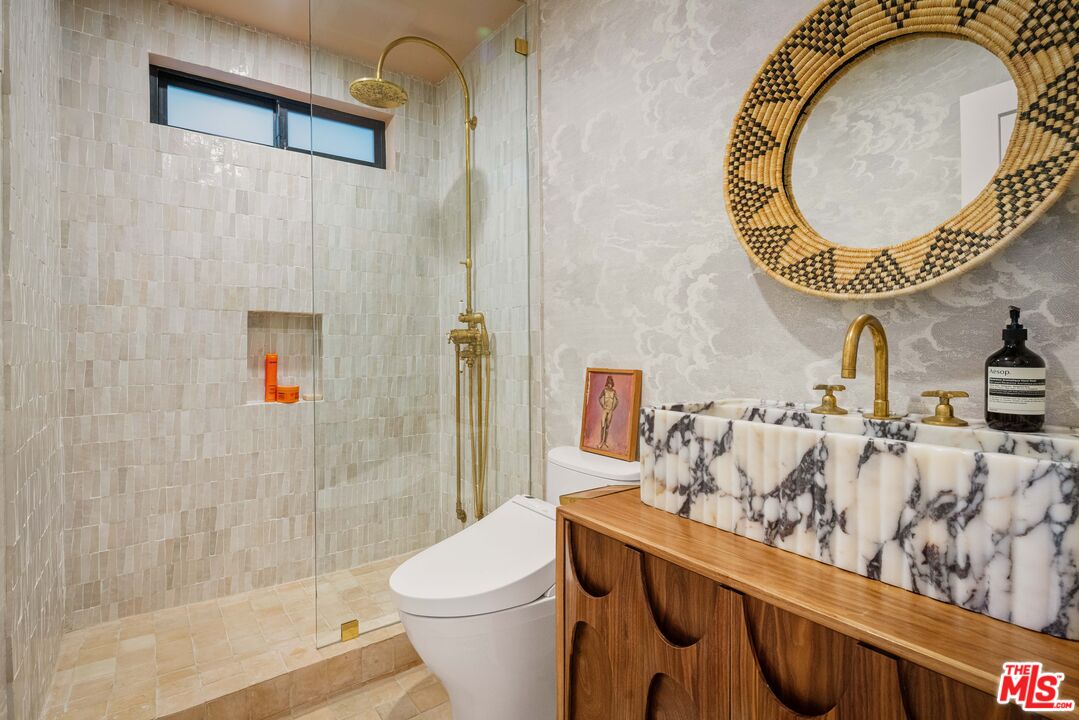 29500 Heathercliff Road, Unit 138 Malibu, CA 90265 - Photo 12 of 20 a bathroom with a sink a toilet and a shower