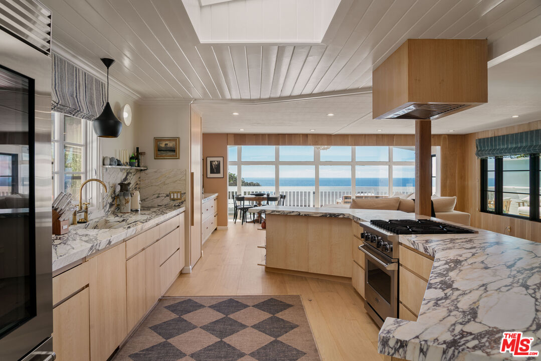 29500 Heathercliff Road, Unit 138 Malibu, CA 90265 - Photo 6 of 20 a kitchen with a sink stove top oven and cabinets