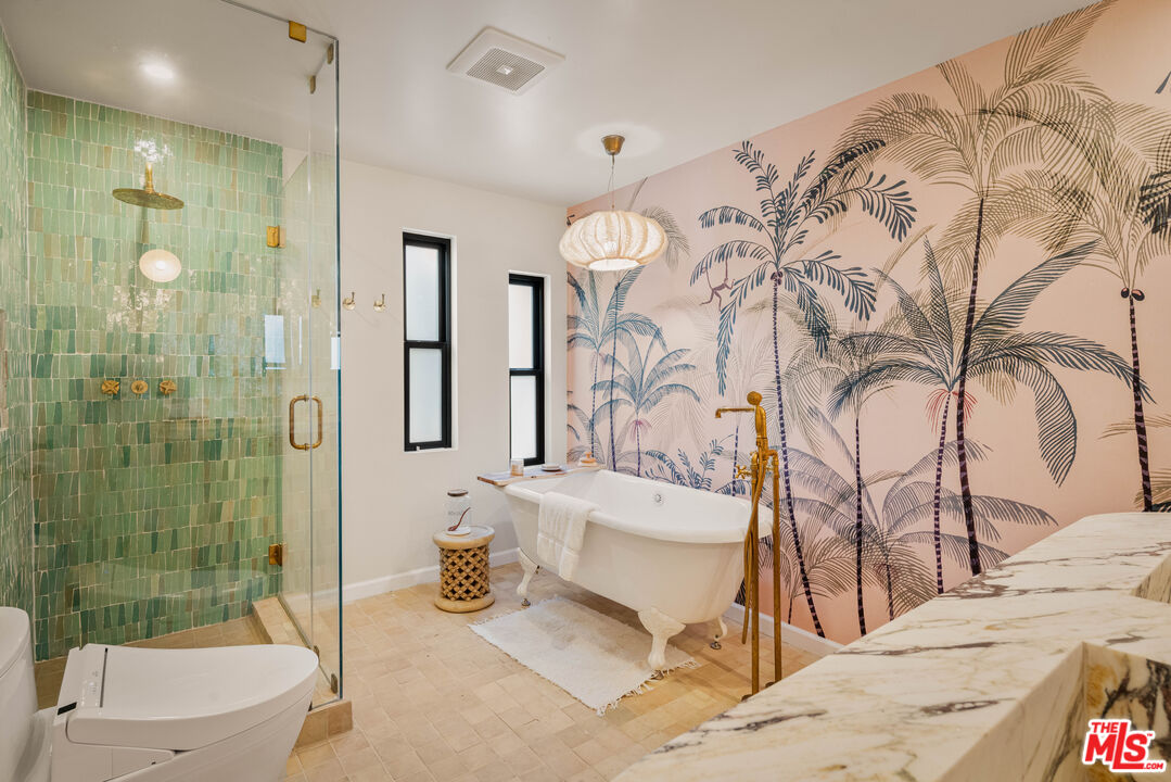 29500 Heathercliff Road, Unit 138 Malibu, CA 90265 - Photo 9 of 20 a bathroom with a granite countertop sink a toilet and shower
