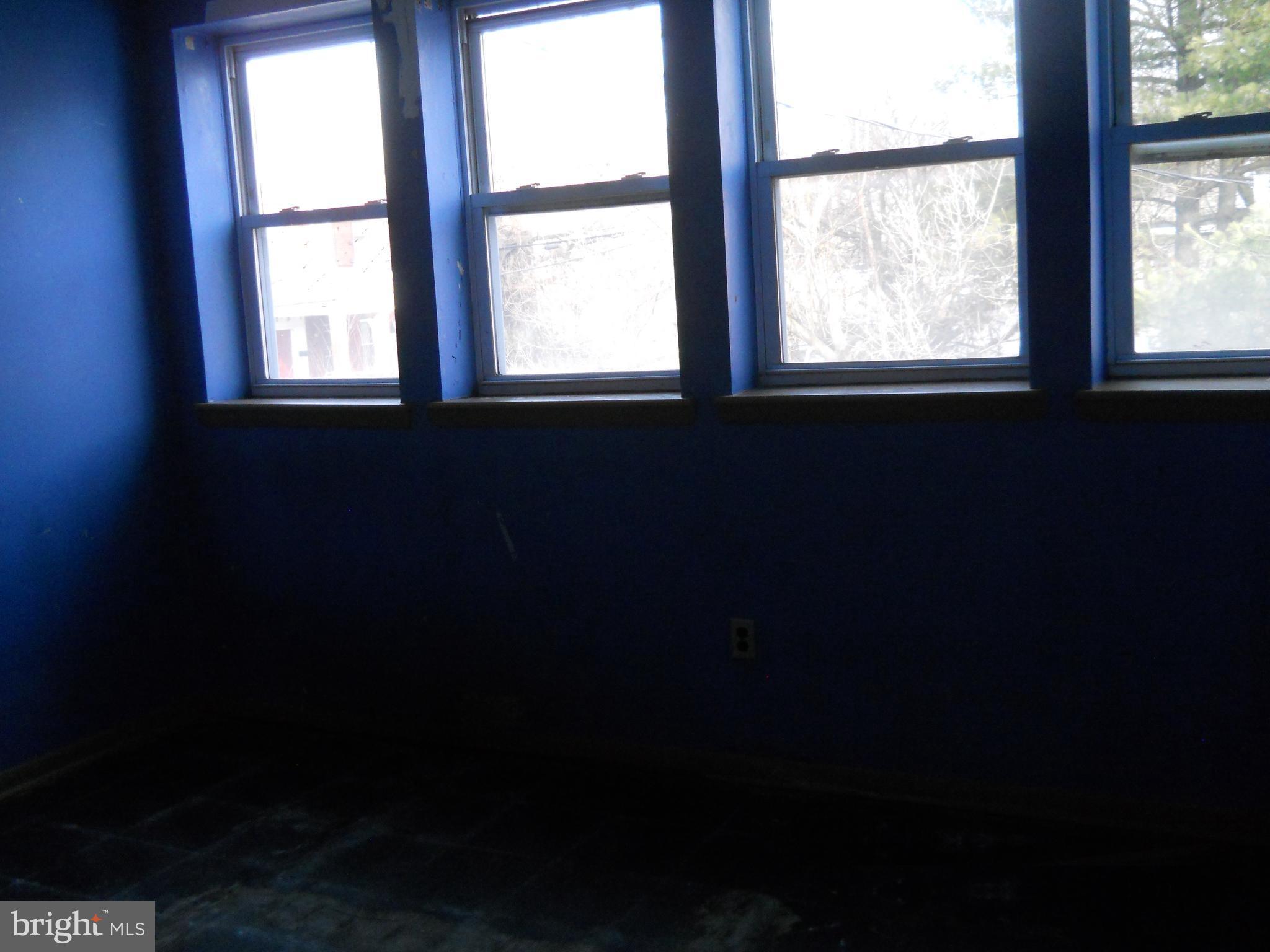 3755 Reisterstown Road Baltimore, MD 21215 - Photo 8 of 11 a view of an empty room with a window