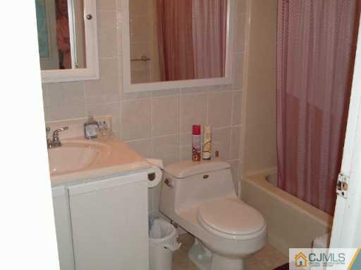 4701 Hana Road Edison, NJ 08817 - Photo 8 of 8 a bathroom with a sink toilet and vanity