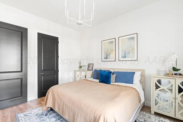 a bedroom with a bed and a mirror