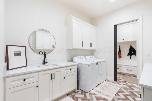 a utility room with cabinets washer and dryer
