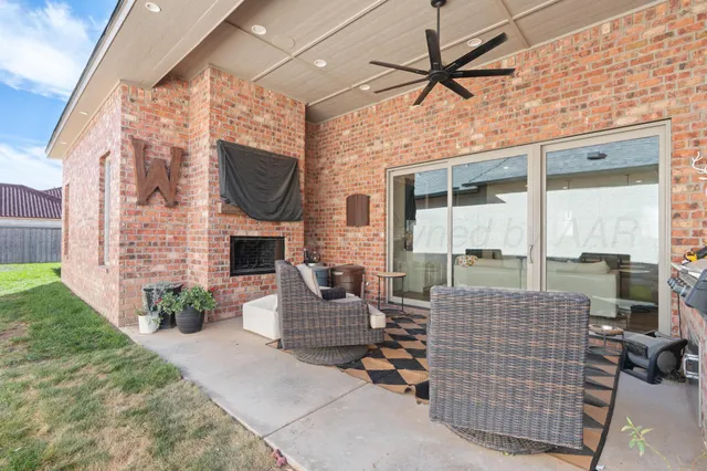 a outdoor space with patio the couches and a fireplace