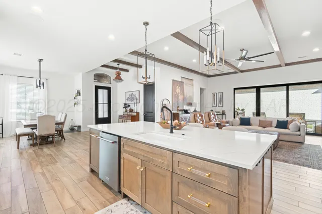 a large kitchen with kitchen island a lot of counter space