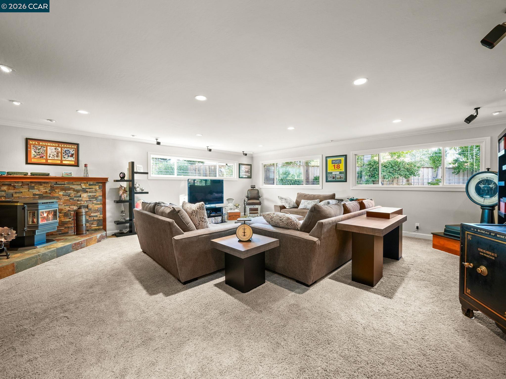 5900 High Street Clayton, CA 94517 - Photo 10 of 46 a living room with furniture a fireplace a flat screen tv and a window