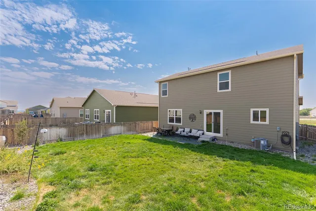 a view of a house with a yard porch and sitting area