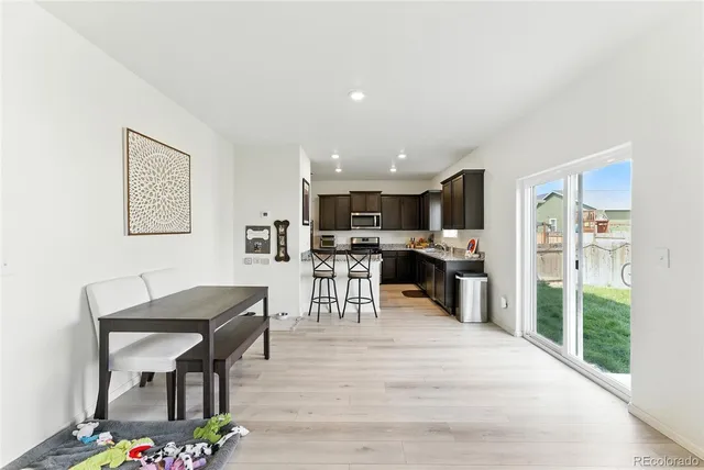 a living room with furniture and a kitchen view