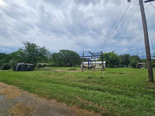 a backyard of a house with a yard and outdoor seating