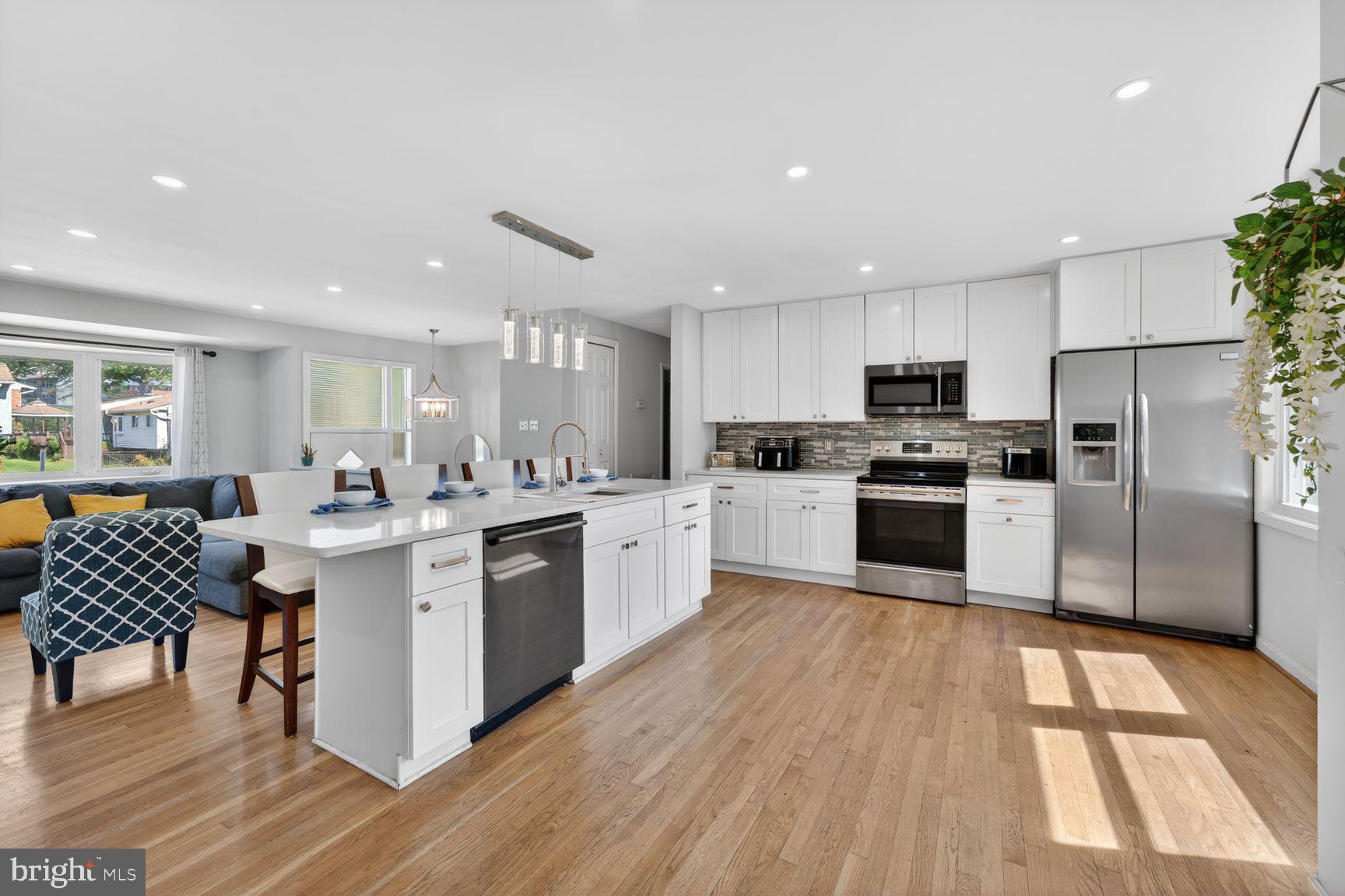 1104 Caddington Avenue Silver Spring, MD 20901 - Photo 7 of 35 a kitchen with white cabinets and stainless steel appliances