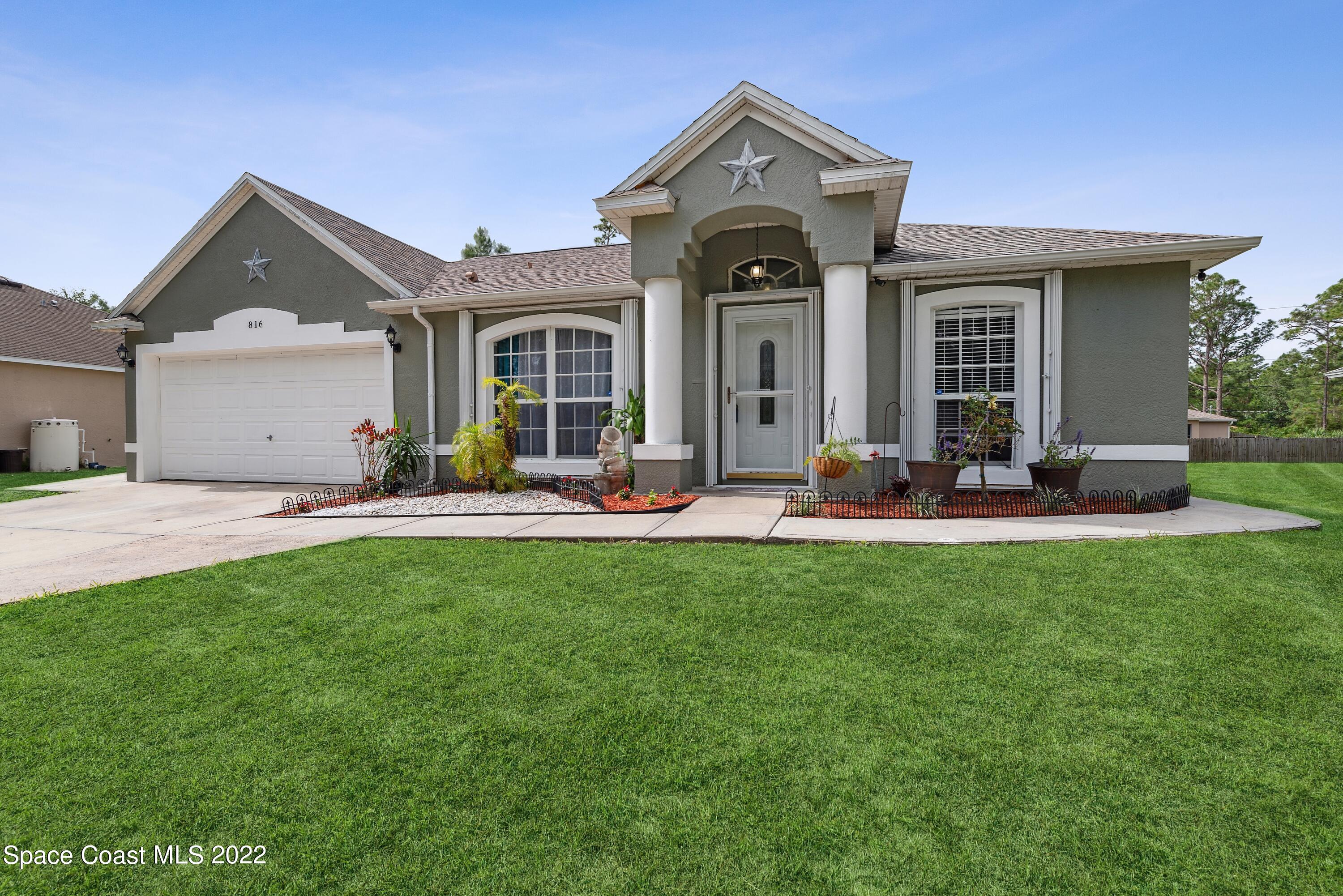 816 Tedder Road Southeast Palm Bay, FL 32909 - Photo 1 of 18 01_816TedderRd_57_FrontView_HiRes