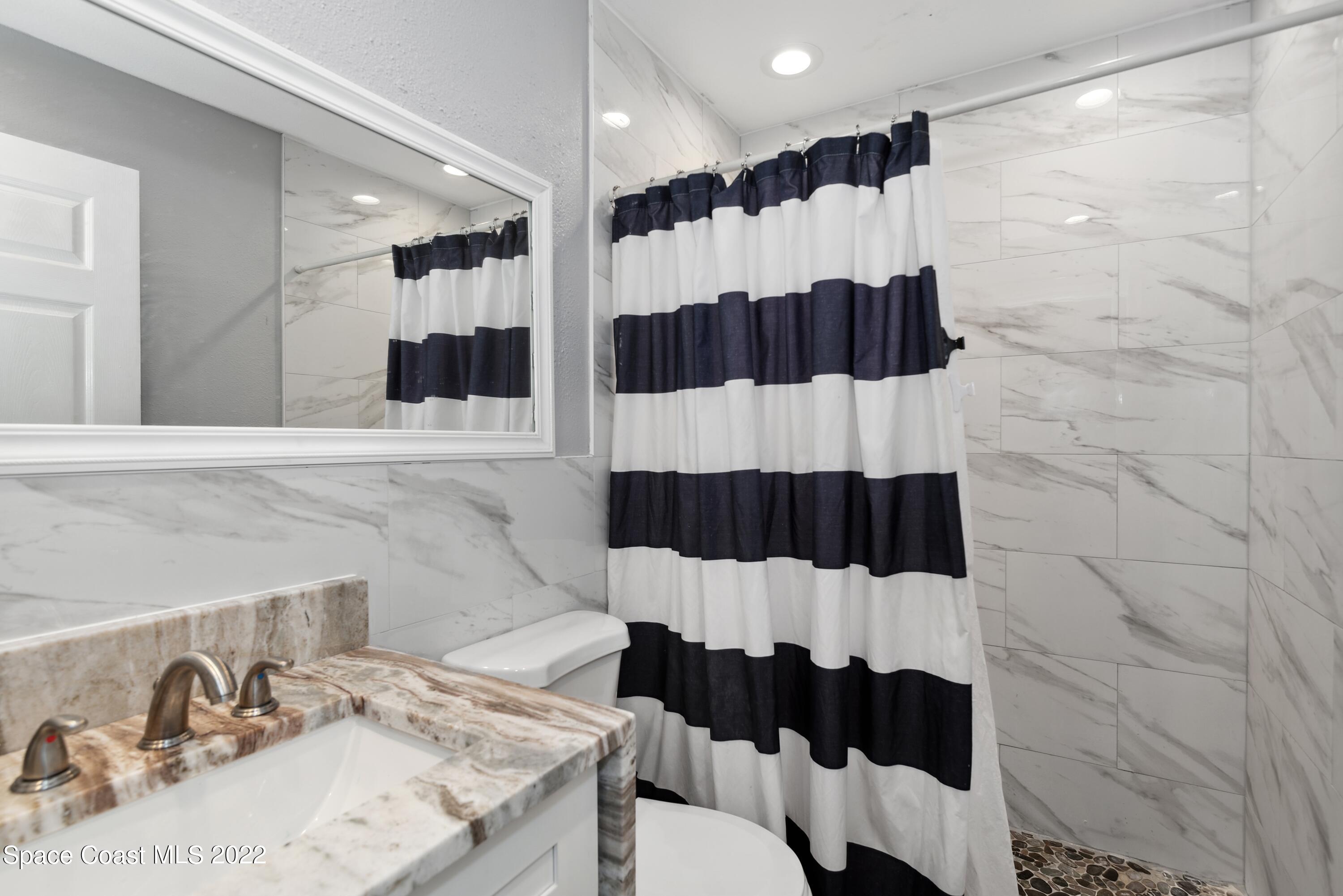 816 Tedder Road Southeast Palm Bay, FL 32909 - Photo 11 of 18 12_816TedderRd_8_Bathroom_HiRes